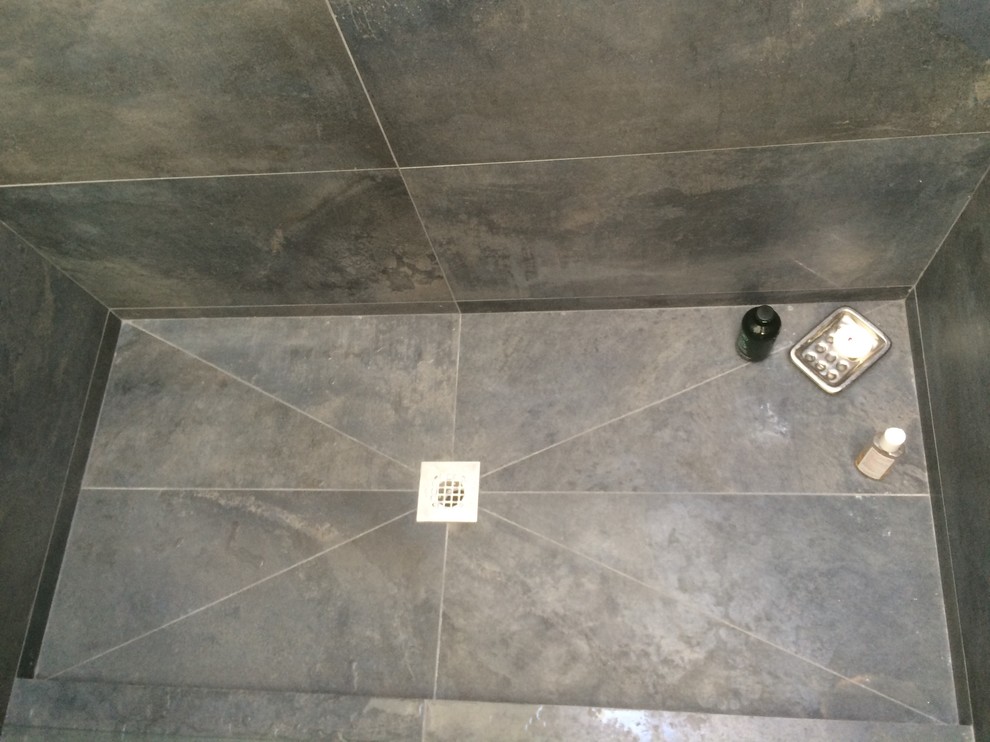 Example of a mid-sized trendy 3/4 gray tile and slate tile slate floor and gray floor alcove shower design in Orange County with flat-panel cabinets, medium tone wood cabinets, a two-piece toilet, gray walls, a vessel sink, quartz countertops and a hinged shower door