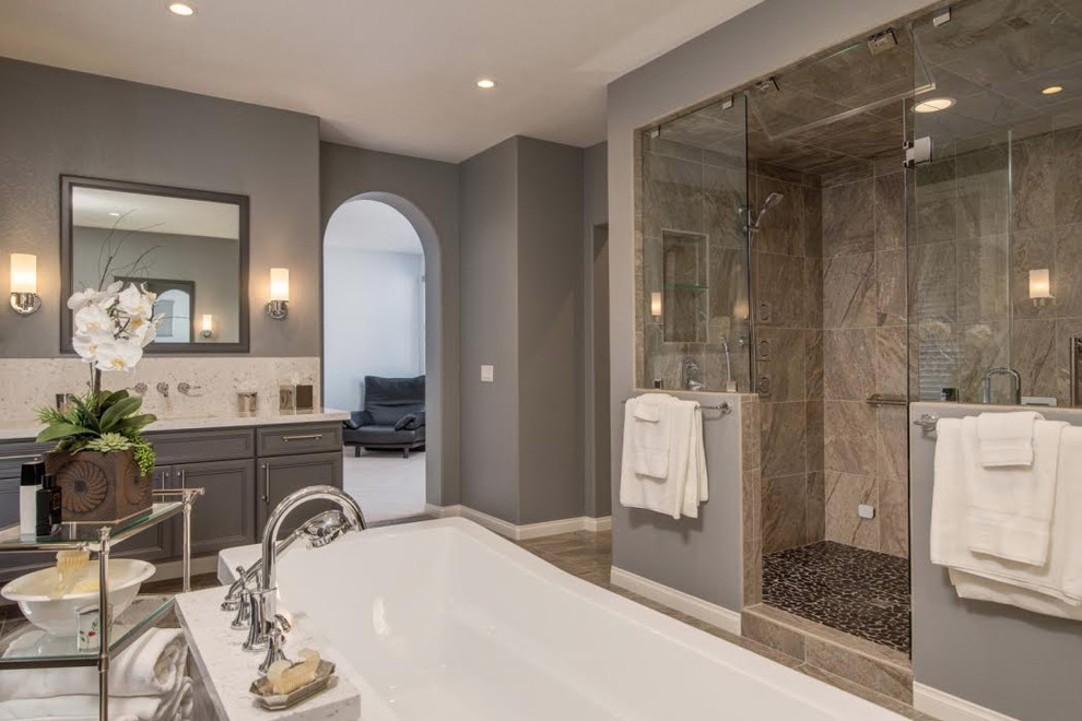 Example of a mid-sized transitional master beige tile and porcelain tile porcelain tile and beige floor bathroom design in San Francisco with recessed-panel cabinets, gray cabinets, a two-piece toilet, beige walls, an undermount sink, limestone countertops and a hinged shower door