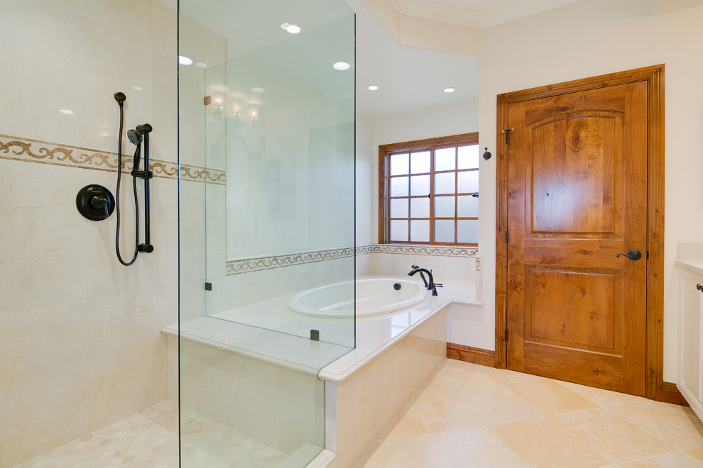 Photo of a large mediterranean ensuite bathroom in Los Angeles with a built-in bath, a corner shower, beige tiles, stone tiles, white walls and travertine flooring.