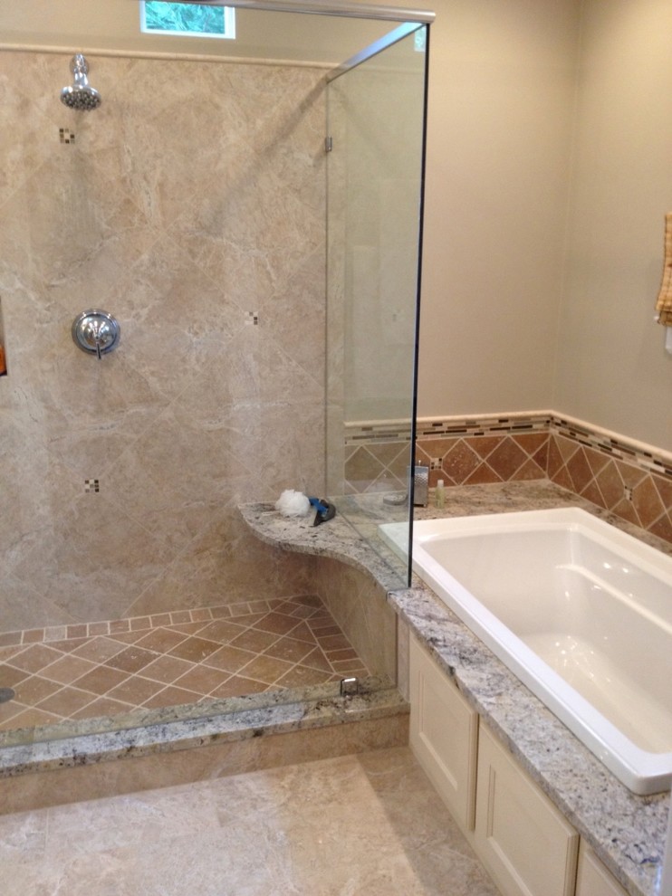 Inspiration for a mid-sized timeless master beige tile, brown tile and ceramic tile travertine floor bathroom remodel in Charlotte with recessed-panel cabinets, white cabinets, a one-piece toilet, beige walls, an undermount sink and granite countertops