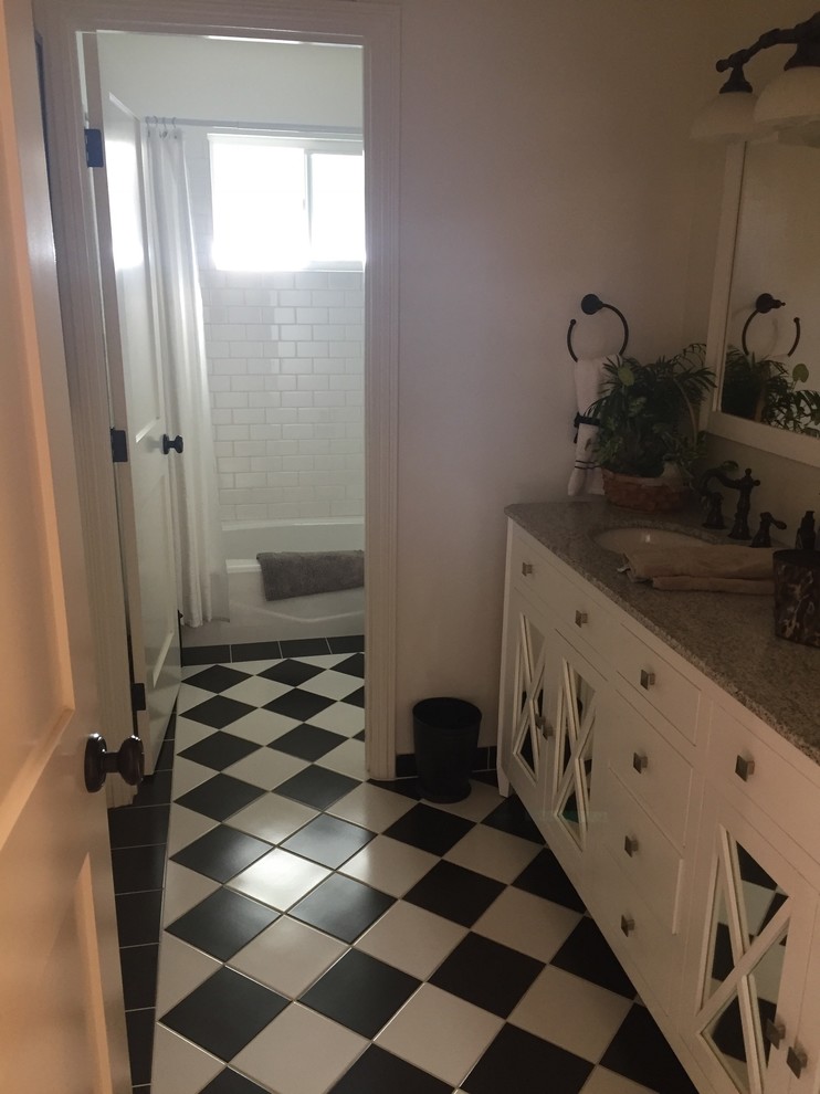 Example of a small transitional master white tile and subway tile black floor bathroom design in San Francisco with glass-front cabinets, white cabinets, white walls, an undermount sink, granite countertops and gray countertops