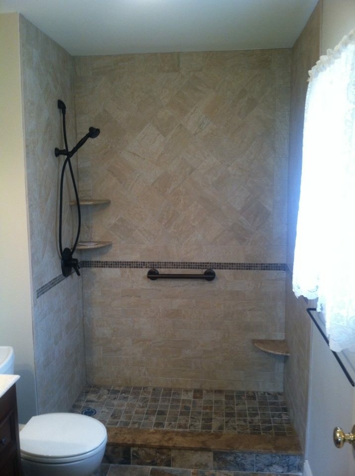 Photo of a medium sized classic shower room bathroom in New York with an alcove shower, a two-piece toilet, brown tiles and stone tiles.