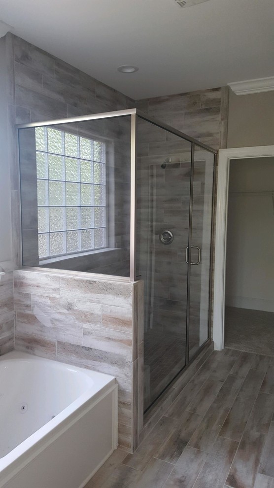 Aménagement d'une salle de bain principale de taille moyenne avec une baignoire en alcôve, une douche d'angle, un mur marron, parquet clair, un sol marron et une cabine de douche à porte battante.