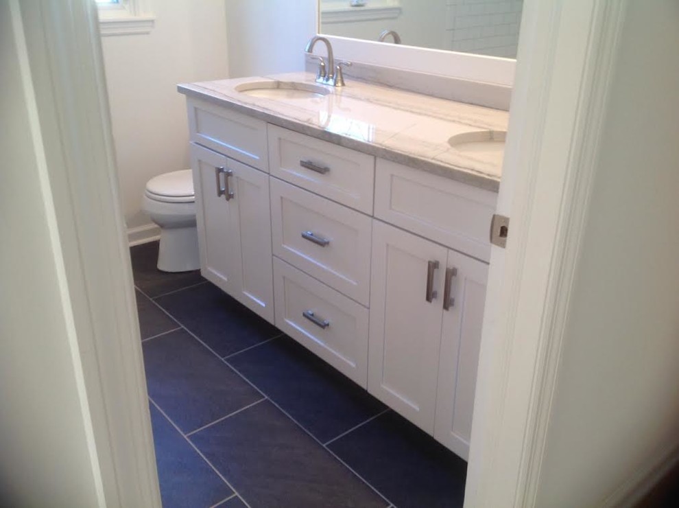 Example of a mid-sized transitional master white tile and subway tile slate floor and black floor alcove shower design in Indianapolis with shaker cabinets, white cabinets, a one-piece toilet, gray walls, an undermount sink and quartzite countertops