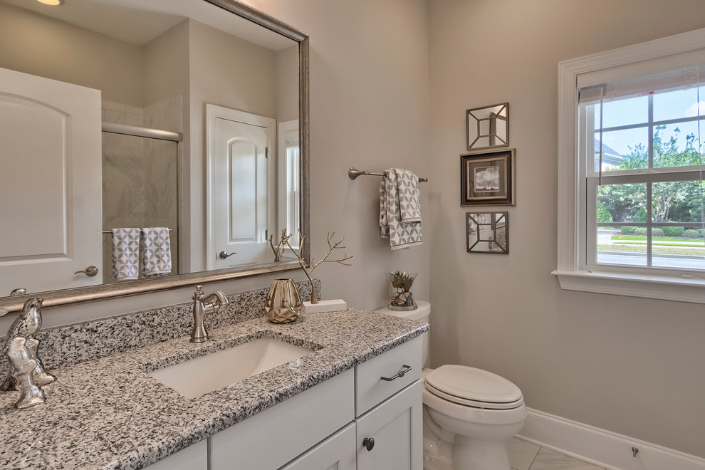 Medium sized traditional ensuite bathroom in San Diego with recessed-panel cabinets, white cabinets, an alcove bath, a shower/bath combination, white tiles, marble tiles, beige walls, marble flooring, a submerged sink and granite worktops.