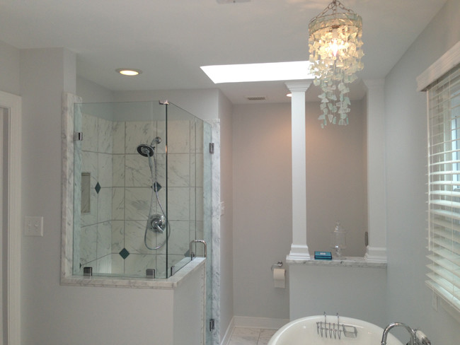 Exempel på ett mellanstort klassiskt en-suite badrum, med ett undermonterad handfat, skåp i shakerstil, grå skåp, marmorbänkskiva, ett fristående badkar, en hörndusch, en vägghängd toalettstol, vit kakel, stenkakel, blå väggar och marmorgolv