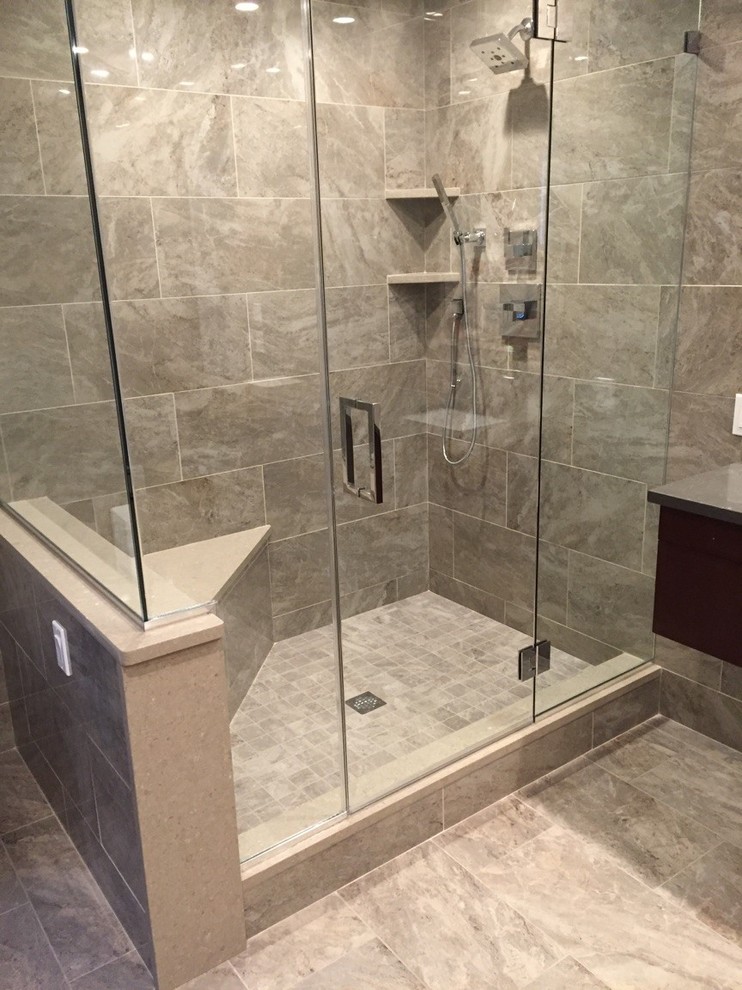 Example of a mid-sized minimalist master beige tile, gray tile and porcelain tile ceramic tile alcove shower design in New York with flat-panel cabinets, dark wood cabinets, a one-piece toilet, gray walls and solid surface countertops