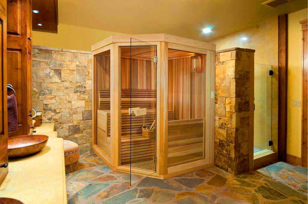 Example of a mid-sized southwest master corner shower design in Other with raised-panel cabinets, medium tone wood cabinets, yellow walls, a vessel sink and quartz countertops