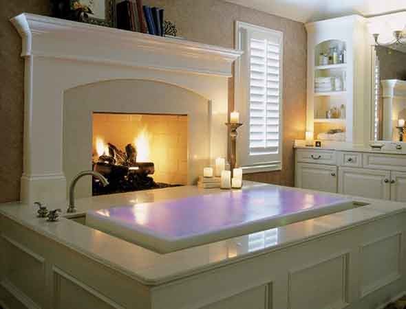 Design ideas for a large traditional ensuite bathroom in Cleveland with raised-panel cabinets, white cabinets, a built-in bath, beige walls and marble worktops.