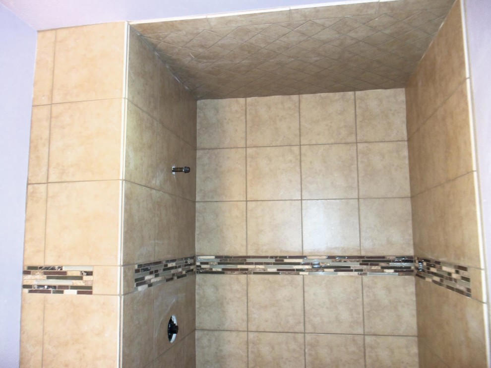 Alcove shower - mid-sized traditional beige tile and ceramic tile alcove shower idea in San Diego with raised-panel cabinets, medium tone wood cabinets and granite countertops