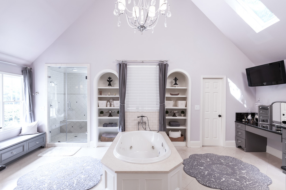 Inspiration for a large traditional ensuite bathroom in Atlanta with a built-in bath, an alcove shower, recessed-panel cabinets, grey cabinets, grey walls, a submerged sink, granite worktops, beige floors and a hinged door.