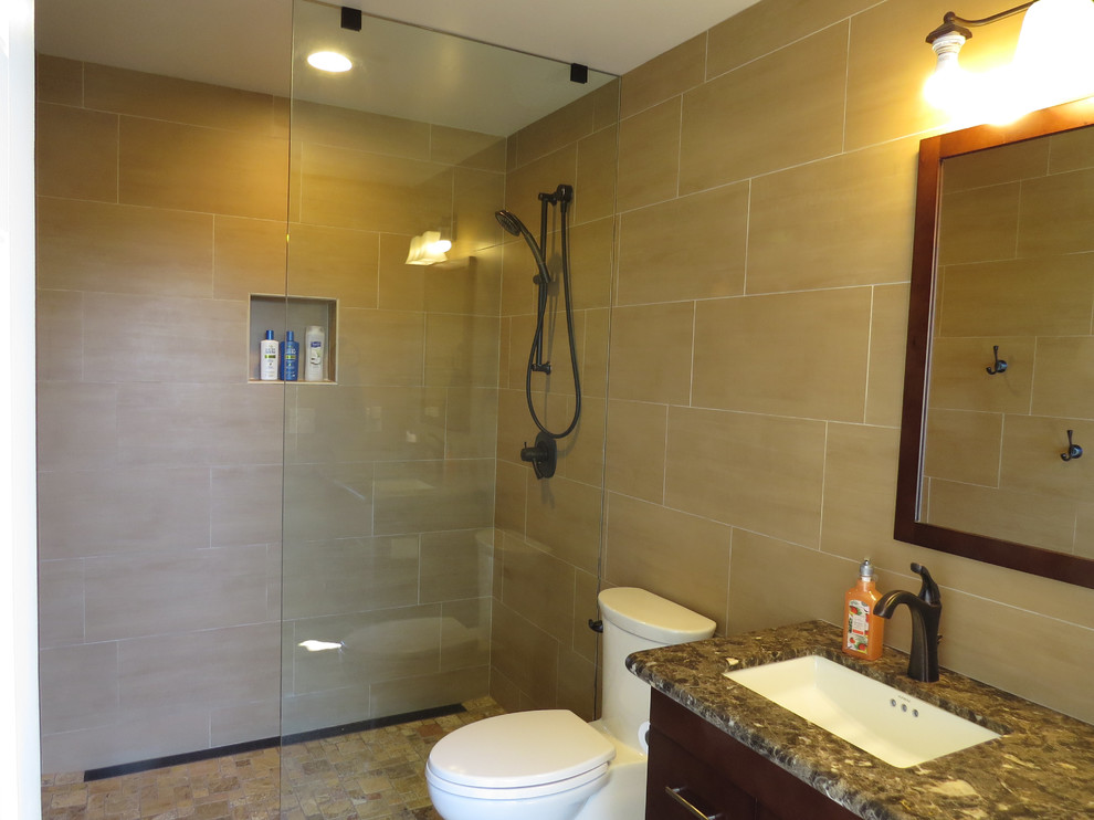 Example of a classic beige tile and porcelain tile travertine floor and beige floor bathroom design in San Luis Obispo with a one-piece toilet, beige walls, an undermount sink, flat-panel cabinets, dark wood cabinets and granite countertops