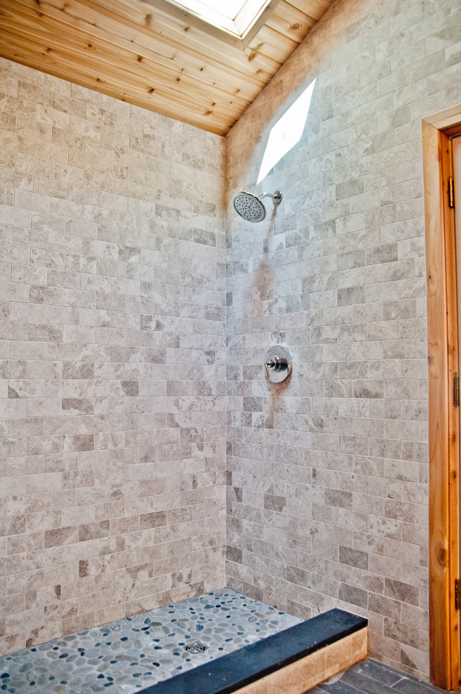 This is an example of a large contemporary shower room bathroom in New York with shaker cabinets, dark wood cabinets, a walk-in shower, a one-piece toilet, beige tiles, grey tiles, stone tiles, multi-coloured walls, a submerged sink and solid surface worktops.