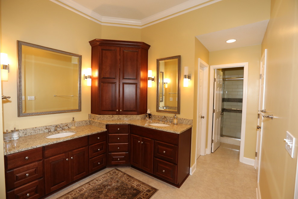 Mid-sized elegant master white tile and ceramic tile ceramic tile and beige floor bathroom photo in Kansas City with raised-panel cabinets, dark wood cabinets, beige walls, an undermount sink and granite countertops