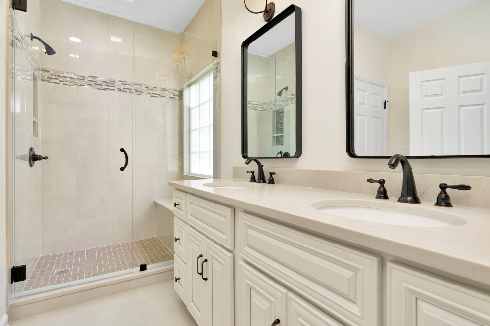 Mid-sized minimalist master white tile and porcelain tile porcelain tile, beige floor and double-sink bathroom photo in Charlotte with raised-panel cabinets, white cabinets, white walls, quartz countertops, beige countertops and a built-in vanity