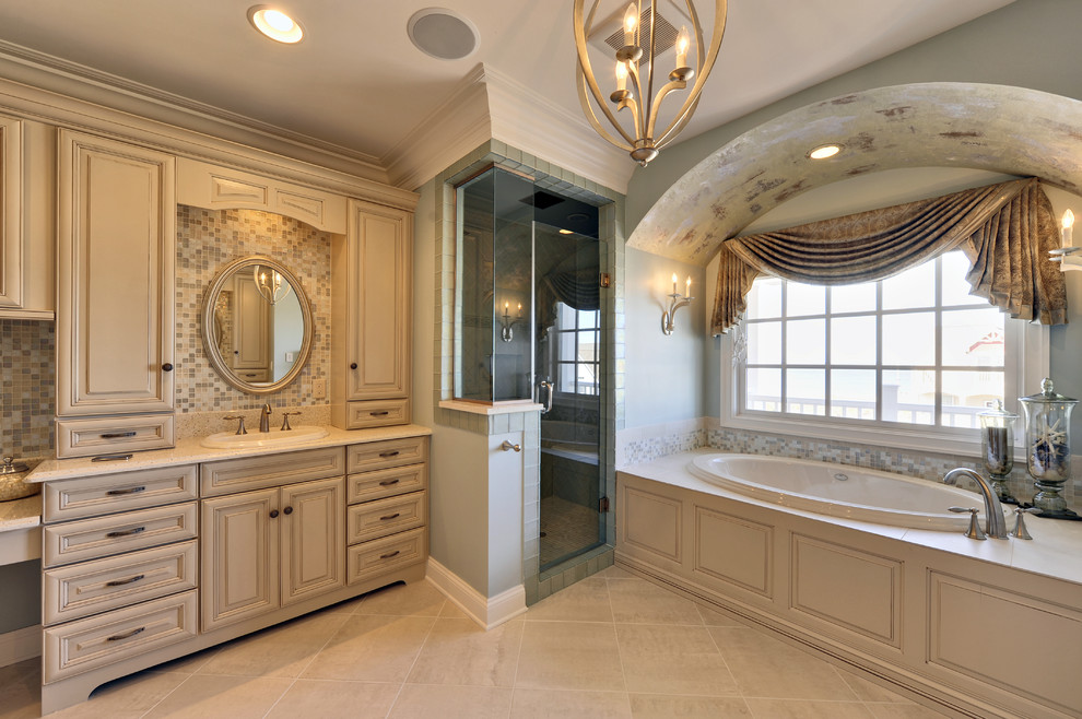 На фото: ванная комната в классическом стиле с накладной раковиной, фасадами с выступающей филенкой, бежевыми фасадами, накладной ванной, угловым душем, бежевой плиткой и плиткой мозаикой
