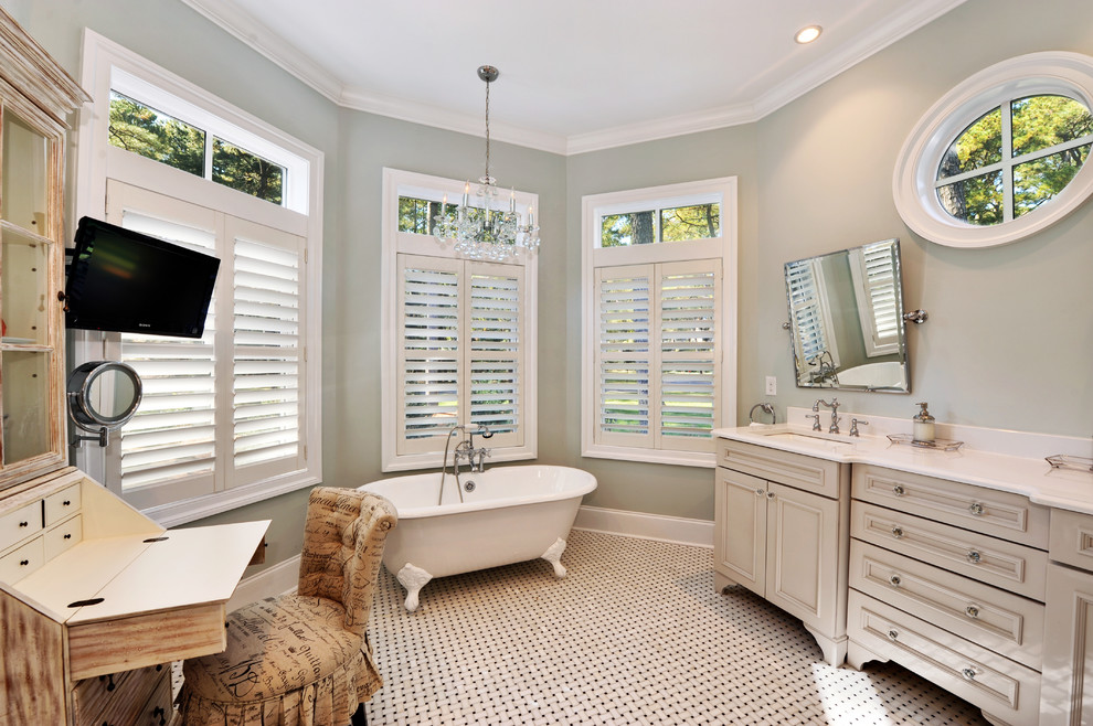 Example of a beach style mosaic tile claw-foot bathtub design in Philadelphia