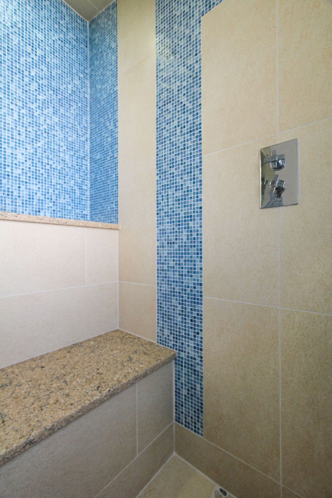 This is an example of an eclectic ensuite bathroom in Baltimore with blue tiles, glass tiles and ceramic flooring.