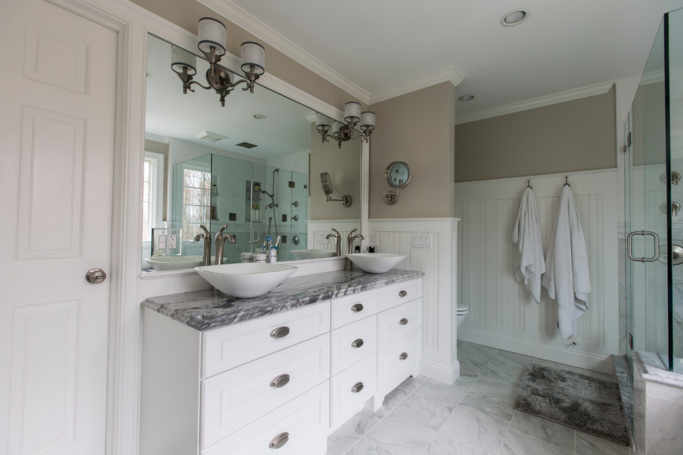 Example of a mid-sized classic master white tile and porcelain tile porcelain tile and white floor bathroom design in Bridgeport with furniture-like cabinets, white cabinets, an undermount tub, a two-piece toilet, beige walls, a vessel sink, marble countertops and a hinged shower door