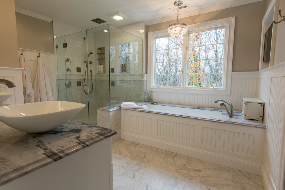 Photo of a medium sized classic ensuite bathroom in Bridgeport with freestanding cabinets, white cabinets, a submerged bath, a two-piece toilet, white tiles, porcelain tiles, beige walls, porcelain flooring, a vessel sink, marble worktops, white floors and a hinged door.