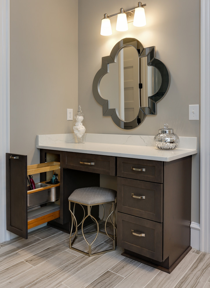 Design ideas for a large classic ensuite bathroom in Raleigh with raised-panel cabinets, medium wood cabinets, a freestanding bath, a corner shower, grey walls, a submerged sink, engineered stone worktops, grey floors, a hinged door and white worktops.