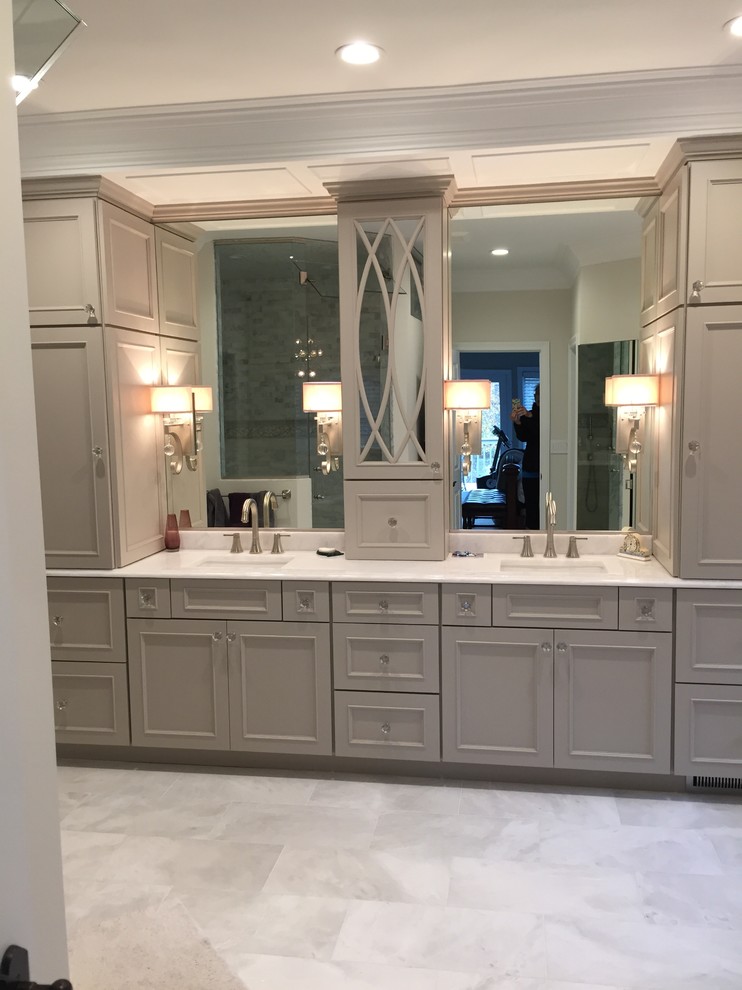 Large classic ensuite bathroom in Chicago with freestanding cabinets, grey cabinets, a freestanding bath, a corner shower, a one-piece toilet, white tiles, marble tiles, white walls, marble flooring, a built-in sink, quartz worktops, grey floors, a hinged door and white worktops.