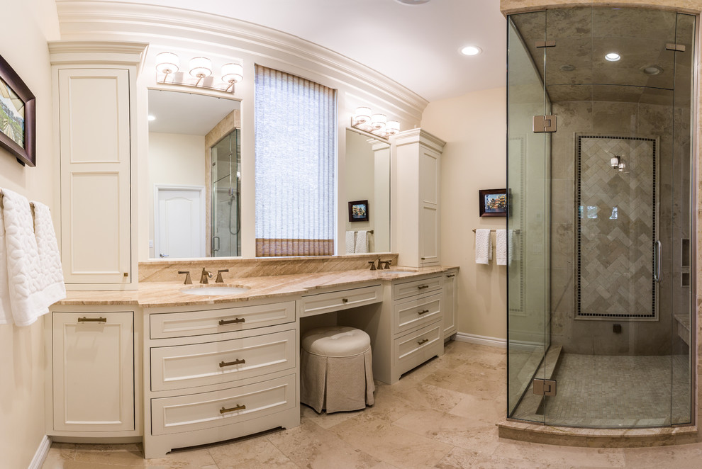 Photo of a medium sized classic ensuite bathroom in Detroit with a submerged sink, beaded cabinets, white cabinets, a corner shower, a bidet, stone tiles and travertine flooring.