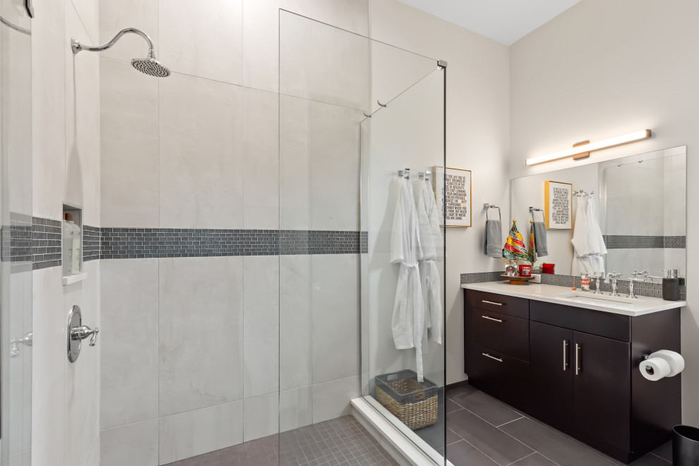 Inspiration for a mid-sized contemporary 3/4 gray tile and stone tile porcelain tile, gray floor and single-sink corner shower remodel in Tampa with flat-panel cabinets, dark wood cabinets, beige walls, an undermount sink, quartz countertops, a hinged shower door, white countertops and a built-in vanity