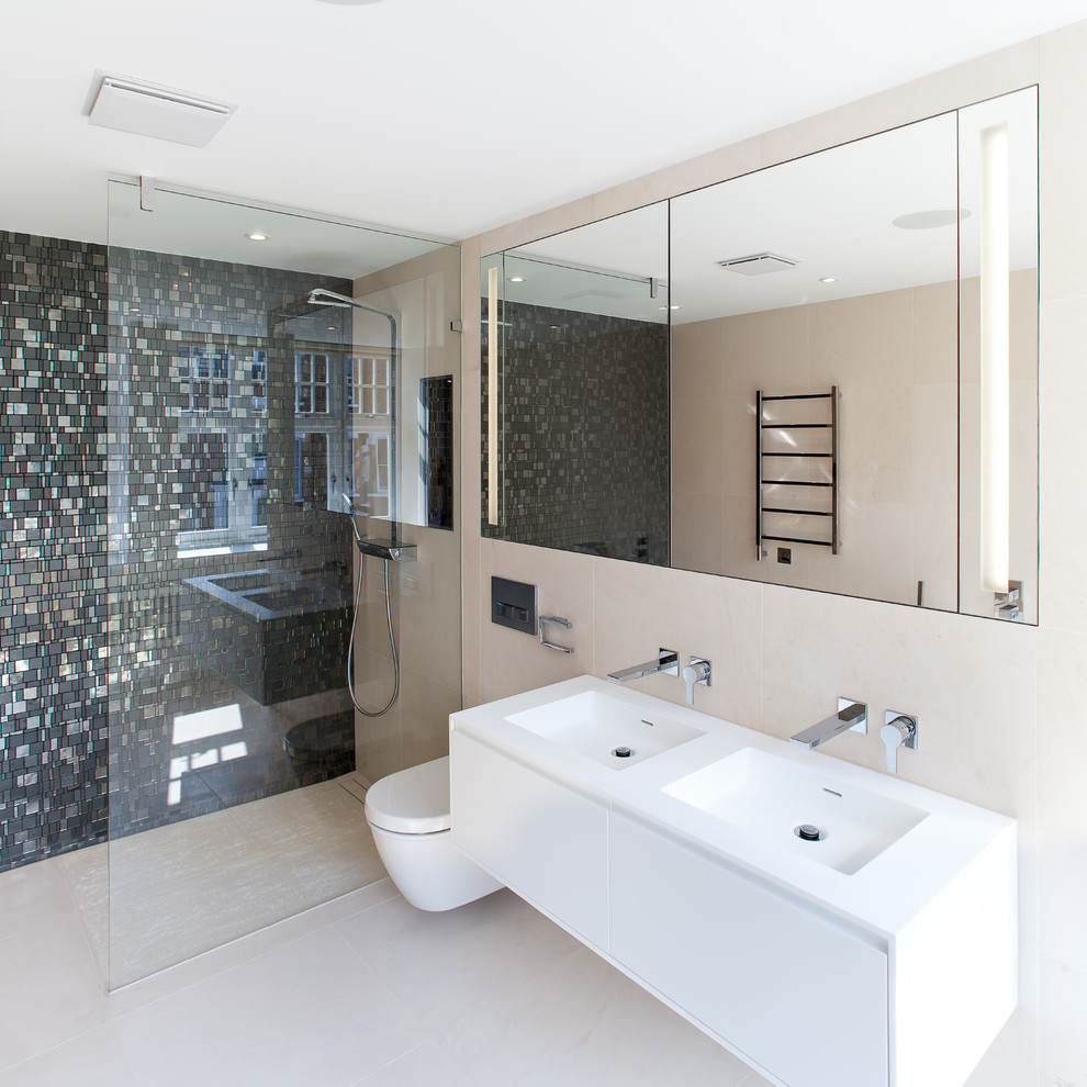 Doorless shower - contemporary black tile doorless shower idea in London with flat-panel cabinets, white cabinets, a wall-mount toilet, beige walls and an integrated sink