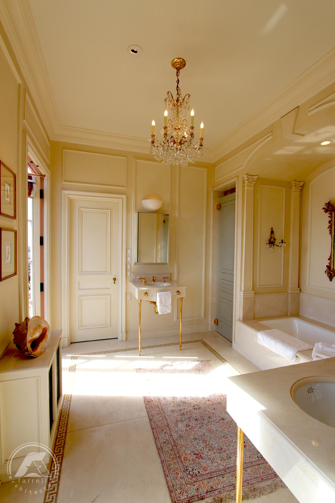 Photo of a large traditional ensuite bathroom in San Francisco with a submerged sink, open cabinets, white cabinets, limestone worktops, a submerged bath, an alcove shower, beige walls and limestone flooring.