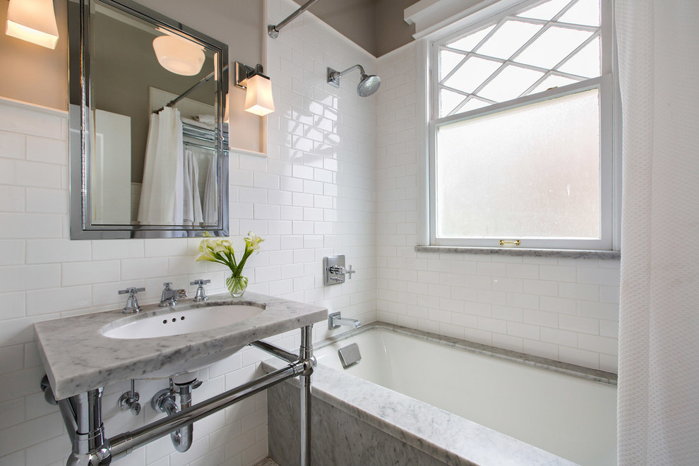 サンフランシスコにあるトランジショナルスタイルのおしゃれな浴室 (アンダーカウンター洗面器、大理石の洗面台、アンダーマウント型浴槽、シャワー付き浴槽	、白いタイル、サブウェイタイル、白い壁、シャワーカーテン) の写真