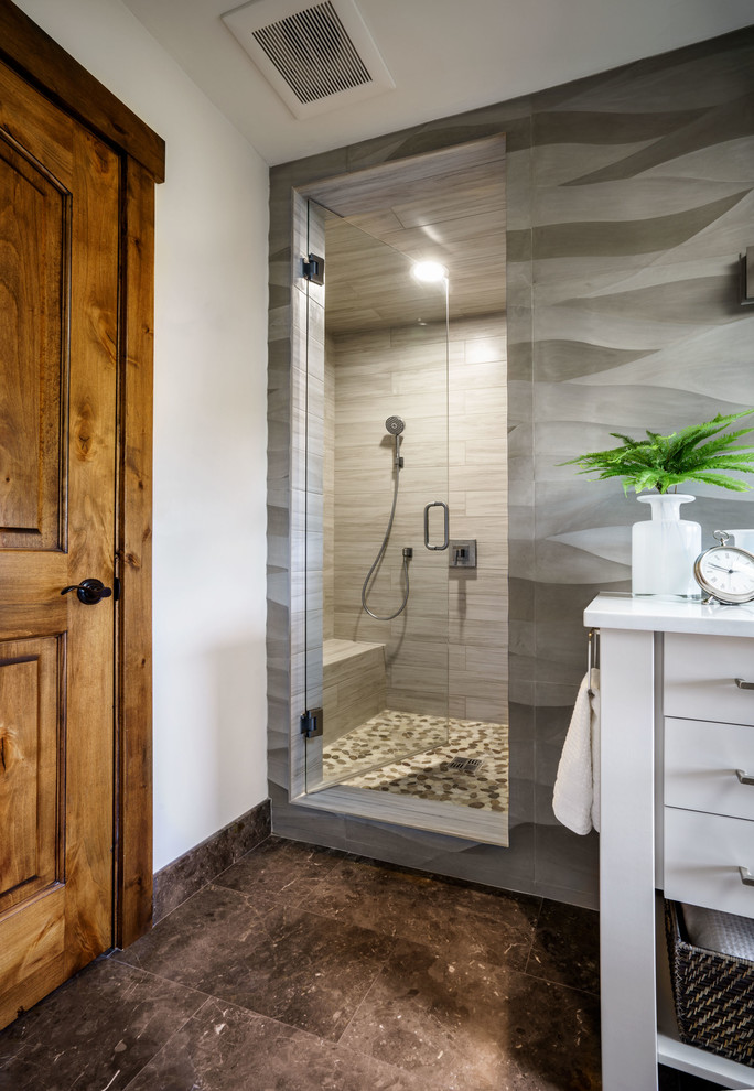 Example of a mid-sized trendy master gray tile and porcelain tile marble floor alcove shower design in Portland with flat-panel cabinets, gray walls, an undermount sink, quartz countertops and gray cabinets