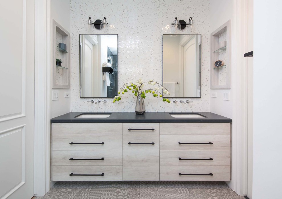 Bathroom - contemporary white tile and mosaic tile gray floor bathroom idea in Los Angeles with flat-panel cabinets, light wood cabinets, white walls, an undermount sink and black countertops