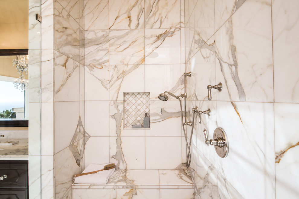 Inspiration for a huge mediterranean master white tile and stone tile marble floor bathroom remodel in Los Angeles with recessed-panel cabinets, dark wood cabinets, a one-piece toilet, beige walls, marble countertops and an undermount sink