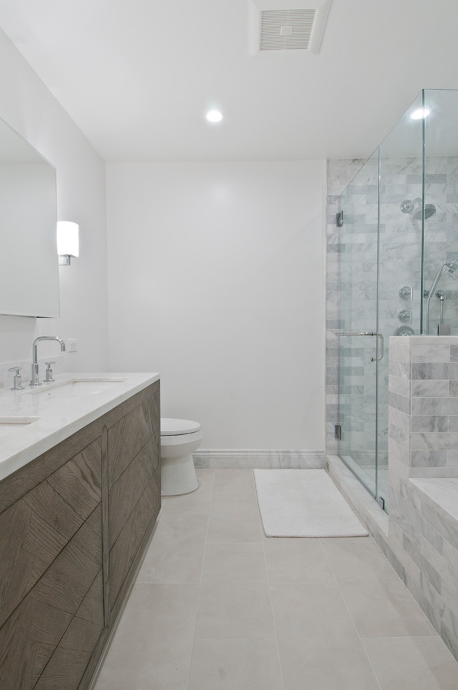 Design ideas for a medium sized traditional ensuite bathroom in Los Angeles with shaker cabinets, medium wood cabinets, a submerged bath, an alcove shower, a one-piece toilet, grey tiles, marble tiles, grey walls, porcelain flooring, a submerged sink, marble worktops, beige floors and a hinged door.