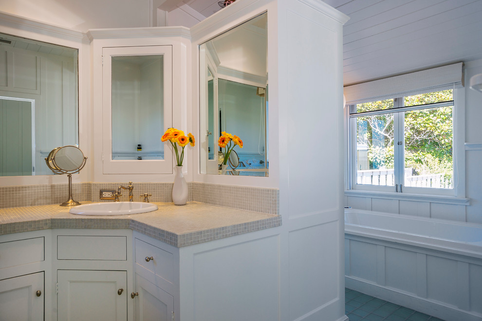 Inspiration for a large beach style ensuite bathroom in Santa Barbara with recessed-panel cabinets, white cabinets, a built-in bath, beige tiles, mosaic tiles, white walls, ceramic flooring, a built-in sink and tiled worktops.