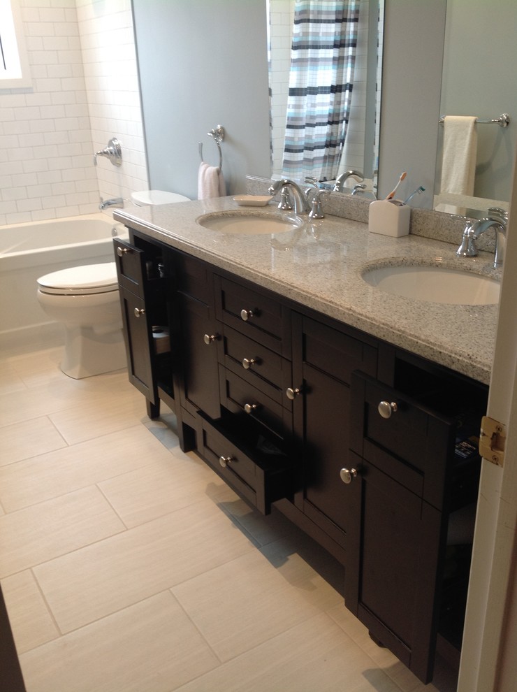 Bathroom - traditional gray tile and porcelain tile bathroom idea in Montreal with an undermount sink, shaker cabinets, dark wood cabinets, granite countertops and a two-piece toilet