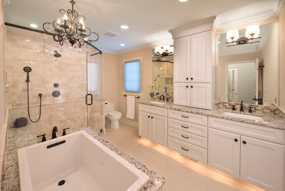 Example of a mid-sized classic master beige tile and porcelain tile porcelain tile bathroom design in Chicago with recessed-panel cabinets, white cabinets, a one-piece toilet, beige walls, an undermount sink and granite countertops