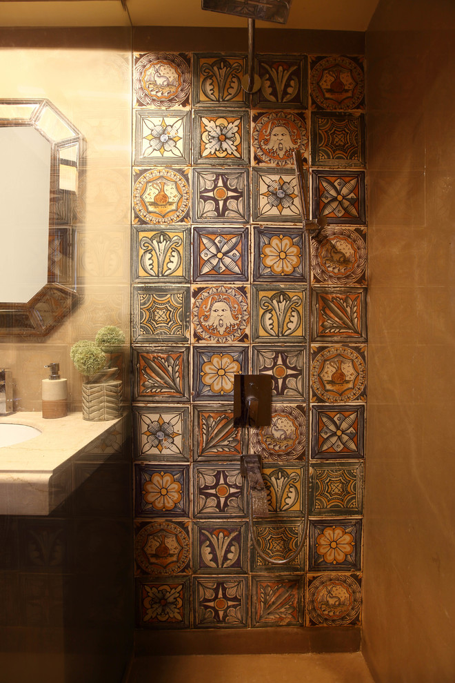 Photo of a small mediterranean bathroom in Pune with flat-panel cabinets, medium wood cabinets, beige tiles and marble worktops.