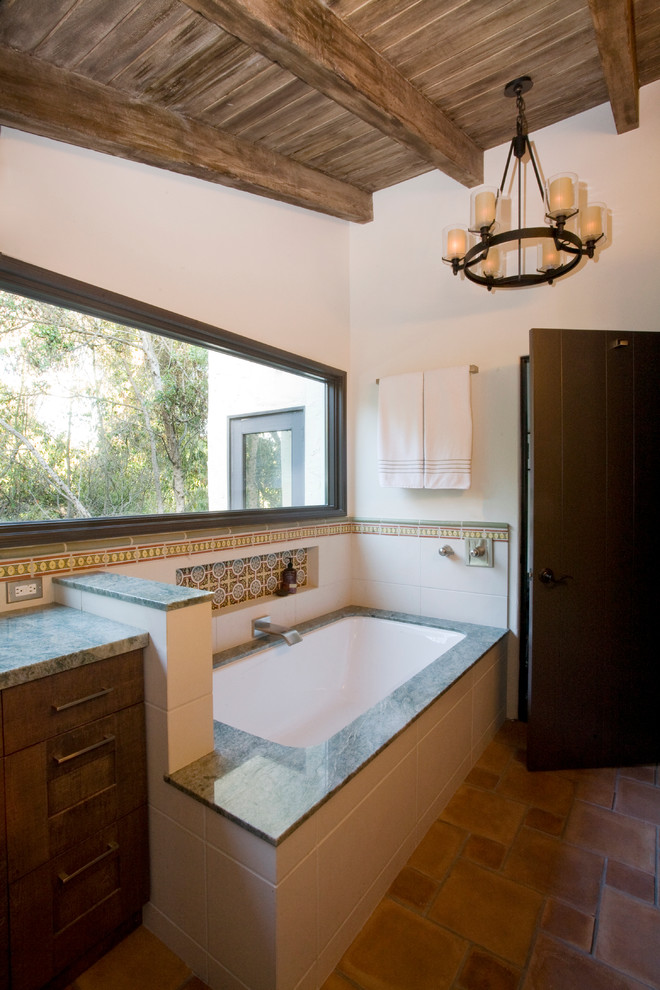 Inspiration for a mid-sized mediterranean master white tile and porcelain tile terra-cotta tile bathroom remodel in Los Angeles with furniture-like cabinets, dark wood cabinets, granite countertops and white walls