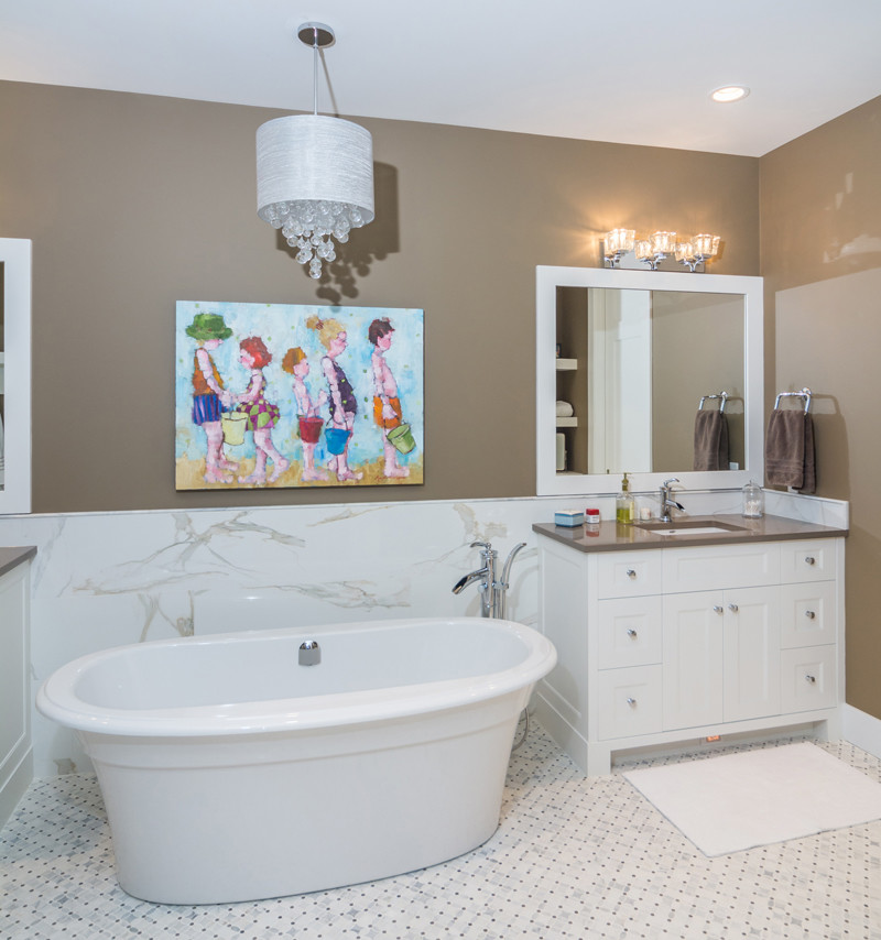 Large modern ensuite bathroom in Calgary with a submerged sink, shaker cabinets, white cabinets, granite worktops, a freestanding bath, a walk-in shower, a one-piece toilet, white tiles, ceramic tiles, beige walls and ceramic flooring.