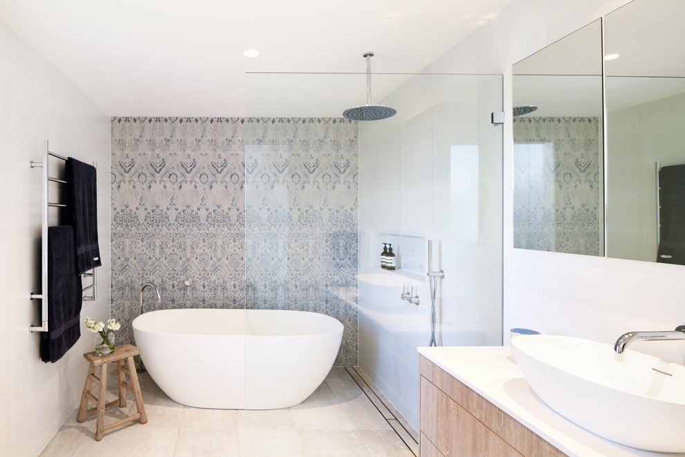 Modern inredning av ett vit vitt badrum, med möbel-liknande, bruna skåp, ett fristående badkar, en dusch i en alkov, vit kakel, vita väggar, klinkergolv i keramik, ett fristående handfat, beiget golv och med dusch som är öppen