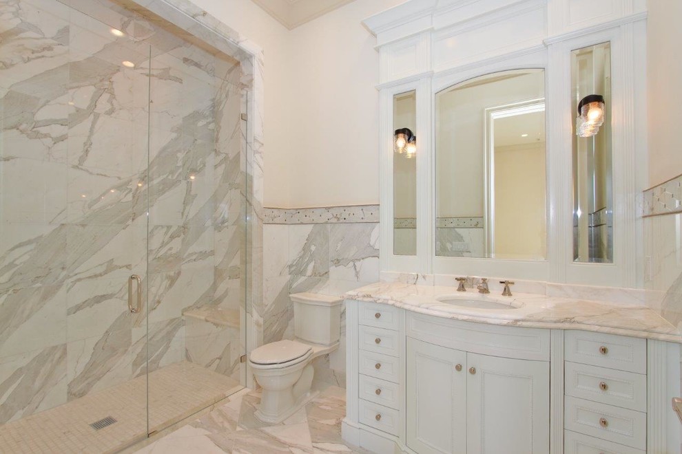 Example of a large classic 3/4 gray tile, white tile and marble tile marble floor and multicolored floor alcove shower design in Miami with beaded inset cabinets, white cabinets, a two-piece toilet, white walls, an undermount sink, marble countertops and a hinged shower door