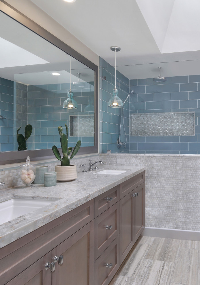 This is an example of a traditional ensuite bathroom in Orange County with shaker cabinets, medium wood cabinets, a submerged bath, a built-in shower, blue tiles, glass tiles, beige walls, marble flooring, a submerged sink, engineered stone worktops, beige floors, an open shower, beige worktops, double sinks and a built in vanity unit.