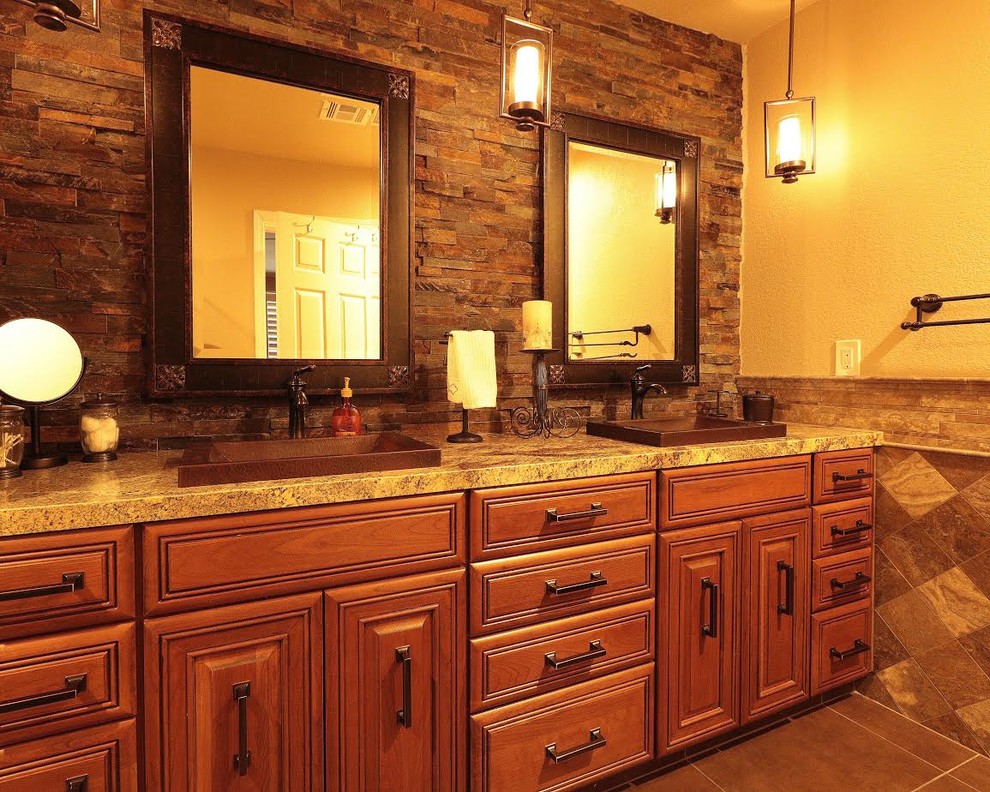 Bathroom - mid-sized traditional master brown tile and stone tile ceramic tile and brown floor bathroom idea in Other with raised-panel cabinets, medium tone wood cabinets, beige walls, a drop-in sink and brown countertops
