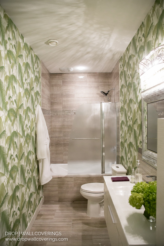This is an example of a small world-inspired shower room bathroom in Vancouver with flat-panel cabinets, light wood cabinets, an alcove bath, a two-piece toilet, grey tiles, porcelain tiles, green walls, an integrated sink and engineered stone worktops.