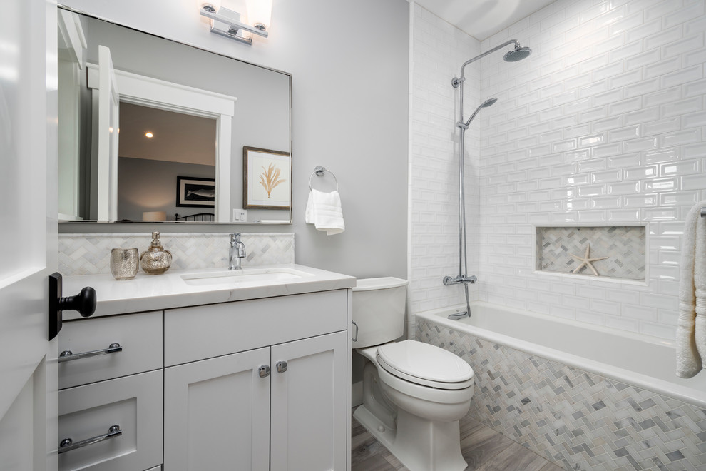 Transitional kids' ceramic tile ceramic tile and gray floor alcove bathtub photo in San Francisco with shaker cabinets, white cabinets, a two-piece toilet, gray walls, an undermount sink, quartz countertops, a hinged shower door and white countertops