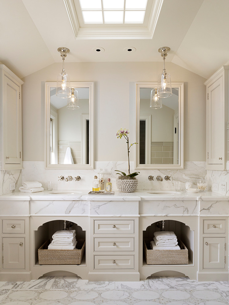 Traditional ensuite bathroom in San Francisco with a submerged sink, beige cabinets, white tiles, beige walls and recessed-panel cabinets.