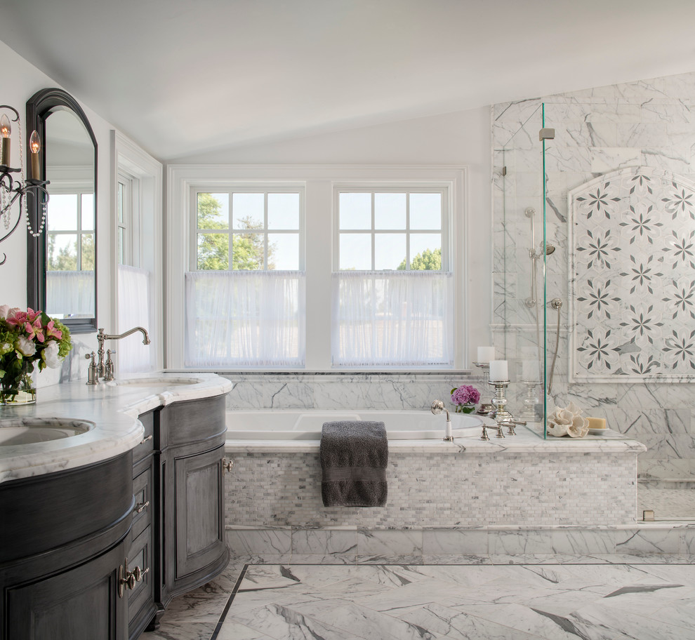 Inspiration for a large timeless master gray tile and stone tile limestone floor bathroom remodel in Los Angeles with recessed-panel cabinets, gray cabinets, white walls, an undermount sink and marble countertops