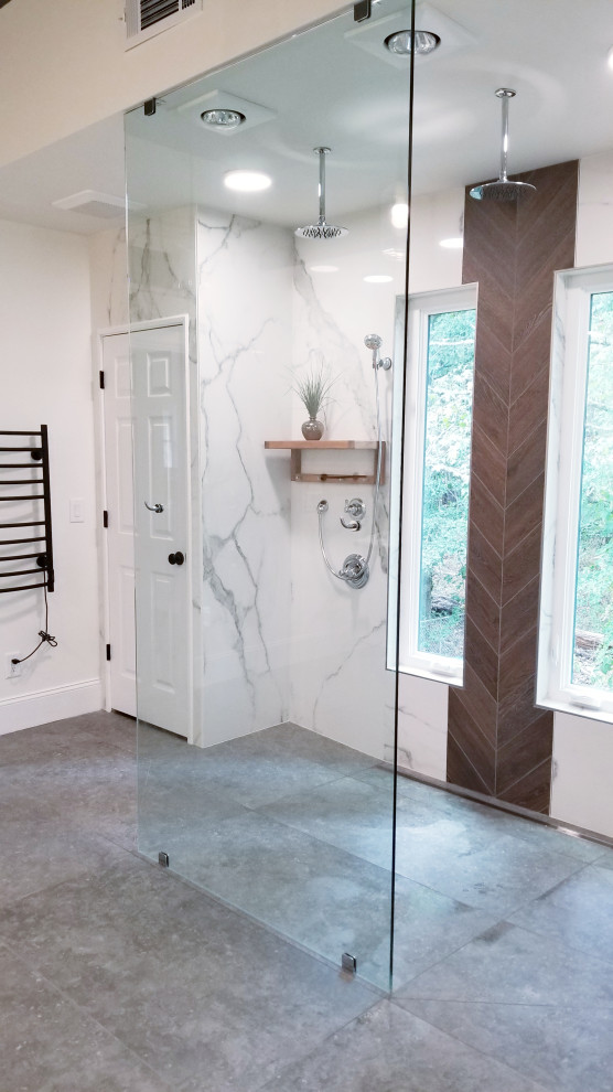 This is an example of an expansive modern ensuite wet room bathroom in Atlanta with open cabinets, light wood cabinets, a freestanding bath, white tiles, porcelain tiles, white walls, porcelain flooring, a pedestal sink, grey floors and an open shower.